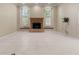 Well-lit living room featuring a fireplace, white-shuttered windows, and tile flooring at 5023 Key Largo Dr, Punta Gorda, FL 33950