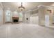 Spacious living room with fireplace, large windows, and tile flooring at 5023 Key Largo Dr, Punta Gorda, FL 33950
