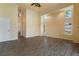 Spacious living room featuring wood floors, large windows, and an adjacent hallway, creating an open flow at 5023 Key Largo Dr, Punta Gorda, FL 33950