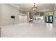 Open concept living room featuring fireplace, Tiffany lighting, and adjacent kitchen at 5023 Key Largo Dr, Punta Gorda, FL 33950