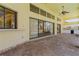 Spacious tiled patio with outdoor kitchen, ceiling fan, and sliding glass doors to the pool area at 5023 Key Largo Dr, Punta Gorda, FL 33950