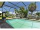 Screened pool overlooks a canal, providing a serene waterfront view at 5023 Key Largo Dr, Punta Gorda, FL 33950