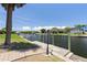 Waterfront view with boat dock featuring a brick walkway, and tropical landscaping at 5023 Key Largo Dr, Punta Gorda, FL 33950