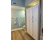 Bright bathroom featuring wood-look floors and built-in white storage cabinets at 5114 Melbourne St # A302, Punta Gorda, FL 33980