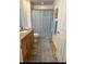 Bathroom with long rug, cabinet vanity and shower with curtain at 5114 Melbourne St # A302, Punta Gorda, FL 33980