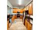 Well-equipped kitchen with stainless steel appliances, wood cabinetry, and granite countertops at 5114 Melbourne St # A302, Punta Gorda, FL 33980