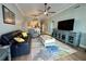 Open-concept living room connected to the kitchen and featuring a comfortable black leather sofa at 5114 Melbourne St # A302, Punta Gorda, FL 33980