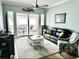 Cozy living room with a comfortable leather sofa, stylish rug, and access to a private balcony at 5114 Melbourne St # A302, Punta Gorda, FL 33980
