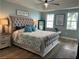 Spacious main bedroom with a king-sized bed, tray ceiling, and plenty of natural light at 5114 Melbourne St # A302, Punta Gorda, FL 33980
