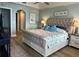 Well-lit main bedroom with a king-sized bed, tray ceiling, and access to an ensuite bathroom at 5114 Melbourne St # A302, Punta Gorda, FL 33980