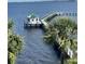 Stunning waterfront view with a charming gazebo at the end of a dock, perfect for relaxation and enjoying the scenery at 5114 Melbourne St # A302, Punta Gorda, FL 33980