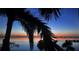 Waterfront view featuring a dock with water access, palm trees adding tropical touch to the serene landscape at 5114 Melbourne St # A302, Punta Gorda, FL 33980
