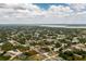 Wide aerial view of a property in a well-spaced residential neighborhood, showing nearby green spaces and community layout at 5532 Veracruz Ter, Port Charlotte, FL 33981