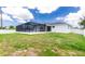 Outdoor backyard space with a screened-in pool and patio in the distance, plus a well-kept lawn at 5532 Veracruz Ter, Port Charlotte, FL 33981