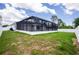 Landscaped backyard featuring a screened-in pool, outdoor patio, and white fenced-in perimeter at 5532 Veracruz Ter, Port Charlotte, FL 33981