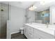 Bathroom featuring double sinks, modern fixtures, and tiled shower with glass door at 5532 Veracruz Ter, Port Charlotte, FL 33981