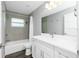Modern bathroom featuring a shower-tub combo with gray tiling and a white vanity at 5532 Veracruz Ter, Port Charlotte, FL 33981
