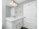Bathroom features white vanity with large mirror, modern lighting, and tiled floor at 5532 Veracruz Ter, Port Charlotte, FL 33981
