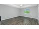 Bright bedroom with hardwood floors, ceiling fan, and natural light from the window at 5532 Veracruz Ter, Port Charlotte, FL 33981