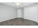 A bright bedroom with wood-look tile floors, a ceiling fan, and ample closet space at 5532 Veracruz Ter, Port Charlotte, FL 33981