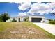 Charming single-story home showcasing a well-manicured lawn, two-car garage and a welcoming front entrance at 5532 Veracruz Ter, Port Charlotte, FL 33981