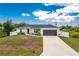 Charming single-story home showcasing a well-manicured lawn, two-car garage and a welcoming front entrance at 5532 Veracruz Ter, Port Charlotte, FL 33981