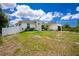 Well-manicured lawn in front of a lovely one-story home and a white fence in the distance at 5532 Veracruz Ter, Port Charlotte, FL 33981
