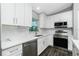 Well-lit kitchen boasting white cabinets, stainless steel appliances, and sleek countertops at 5532 Veracruz Ter, Port Charlotte, FL 33981