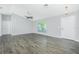 Bright and airy living room featuring stylish flooring, a ceiling fan, and natural light from a large window at 5532 Veracruz Ter, Port Charlotte, FL 33981