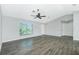 Bright and airy living room featuring stylish flooring, a ceiling fan, and natural light from a large window at 5532 Veracruz Ter, Port Charlotte, FL 33981