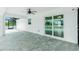Covered patio with stone tile flooring and access to the pool area at 5532 Veracruz Ter, Port Charlotte, FL 33981