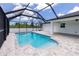 A large screened-in pool with a modern design, surrounded by a stone patio at 5532 Veracruz Ter, Port Charlotte, FL 33981