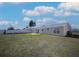 Large backyard view showcasing an expansive lawn, a patio, and a secure fenced perimeter, perfect for outdoor enjoyment at 6850 S Biscayne Dr, North Port, FL 34287