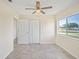 Bedroom with tile floors, a ceiling fan, a window, and a closet for storage at 6850 S Biscayne Dr, North Port, FL 34287