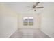 Bedroom with tile floors, a ceiling fan, and a window with a view of the outdoors at 6850 S Biscayne Dr, North Port, FL 34287
