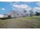 Well-maintained single-story home with a green lawn and a private, fenced backyard at 6850 S Biscayne Dr, North Port, FL 34287
