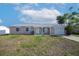 Charming single-story home featuring a well-maintained lawn and attached garage at 6850 S Biscayne Dr, North Port, FL 34287