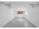 Spacious garage featuring epoxy floors and overhead storage, offering ample space for vehicles and storage at 6850 S Biscayne Dr, North Port, FL 34287