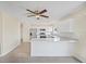 Modern white kitchen with stainless steel appliances, quartz countertops, and a breakfast bar at 6850 S Biscayne Dr, North Port, FL 34287