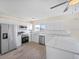 Well-appointed kitchen with stainless steel appliances, white cabinetry, and stylish countertops at 6850 S Biscayne Dr, North Port, FL 34287