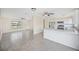Open floor plan combines the living room and kitchen with white cabinets and tile flooring at 6850 S Biscayne Dr, North Port, FL 34287
