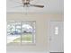 Bright living room, showcasing the front door, and a large window providing natural light at 6850 S Biscayne Dr, North Port, FL 34287
