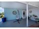 The covered patio has a hanging egg chair, decor and overlooks the side yard at 7231 Elyton Dr, North Port, FL 34287