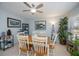 Bright dining area features a ceiling fan and nautical decor at 7231 Elyton Dr, North Port, FL 34287