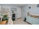 Bright foyer features a white door, tile floors, and nautical themed decor at 7231 Elyton Dr, North Port, FL 34287