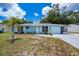 Charming single-story home with a blue exterior, well-kept lawn and white trim around the windows at 7231 Elyton Dr, North Port, FL 34287
