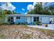 Charming single-story home with a blue exterior, well-kept lawn and white trim around the windows at 7231 Elyton Dr, North Port, FL 34287