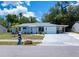 Charming single-story home with a blue exterior, well-kept lawn, attached garage and white trim at 7231 Elyton Dr, North Port, FL 34287