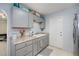 Galley kitchen featuring neutral cabinets, granite countertops, stainless steel appliances, and a sink at 7231 Elyton Dr, North Port, FL 34287