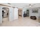 Bright living room with tile floors, barn door details, furnishings, and access to the kitchen at 7231 Elyton Dr, North Port, FL 34287